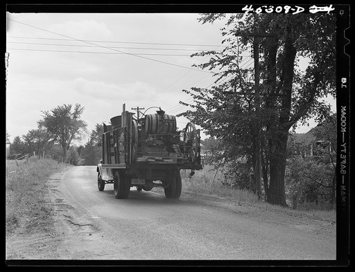 One of the many trucks to be seen carrying a farmer's belongings out of the Pine Camp expansion area. Near Pine Camp, New York