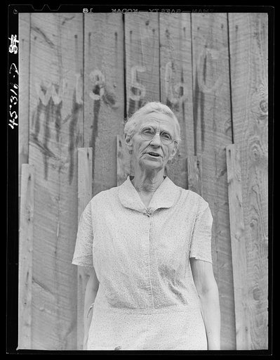 Untitled photo, possibly related to: Mrs. Carrie Ward has lived near Leraysville for seventeen years. Now she is planning to move out of the Army camp area to a small farm in Sandy Creek. Her barn is numbered for auctioning. Leraysville, New York