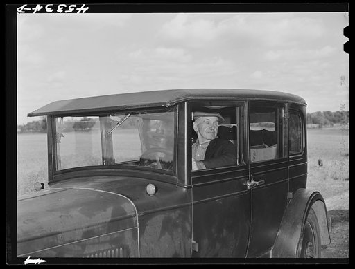Mr. Herbert Alton, a neighbor, helps Mrs. Earl Barbour move from her home in the Pine Camp expansion area to nearby Evans Mills, New York. Alton himself will soon pack up and move to Syracuse, New York. Near Pine Camp, New York
