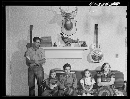 The family of Gottlieb Zahler in their new farm in Lacona, New York, to which they moved from the Pine camp relocation area. In their new home in Lacona, New York