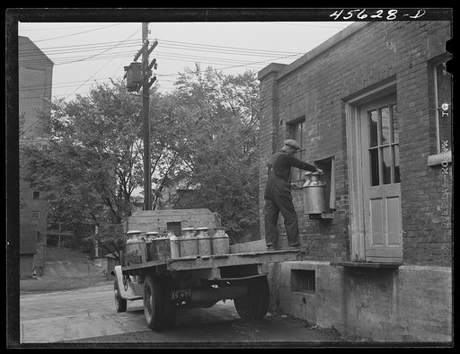 Farmer getting his empty milk cans back at the Burlington cooperative milk bottling plant. Burlington, Vermont