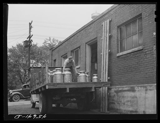 Untitled photo, possibly related to: Farmer getting his empty milk cans back at the Burlington cooperative milk bottling plant. Burlington, Vermont