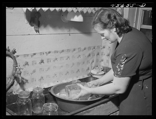 Mrs. William Gaynor washing jars, preparing to can on their farm near Fairfield, Vermont