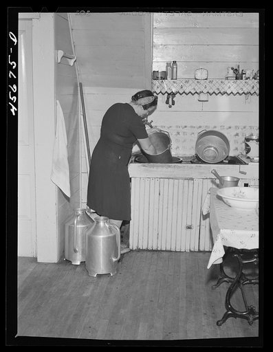 Untitled photo, possibly related to: Mrs. W. Gaynor getting potatoes ready to cook for dinner on the Gaynor farm near Fairfield, Vermont
