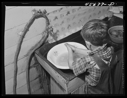 Dicky Gaynor washing his hands on their farm near Fairfield, Vermont