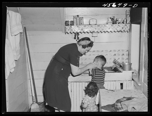 Mrs. Gaynor scrubbing the children's faces before dinner on their farm near Fairfield, Vermont