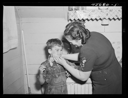 Mrs. Gaynor scrubbing the children's faces before dinner on their farm near Fairfield, Vermont