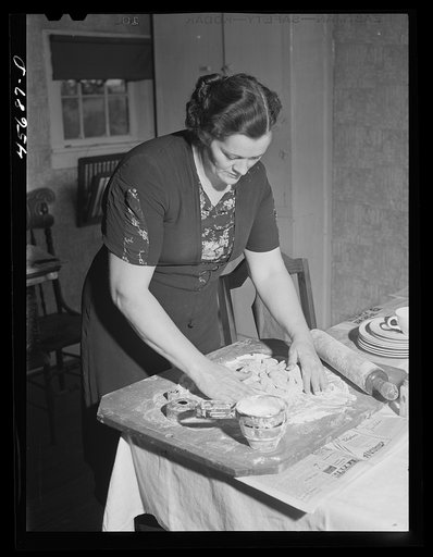 Untitled photo, possibly related to: Mrs. W. Gaynor preparing dinner on their farm near Fairfield, Vermont