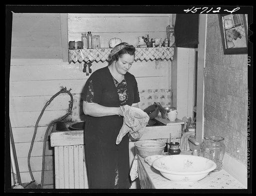Mrs. Gaynor washing dishes on their farm near Fairfield, Vermont
