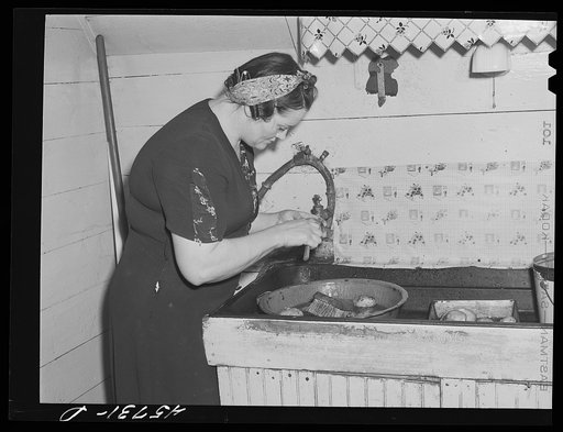 Mrs. W. Gaynor getting potatoes ready to cook for dinner on the Gaynor farm near Fairfield, Vermont