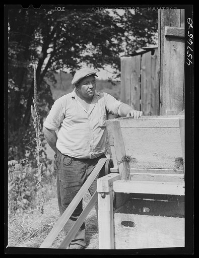 Tunbridge farmer at the cider making machine at the World's Fair. Tunbridge, Vermont