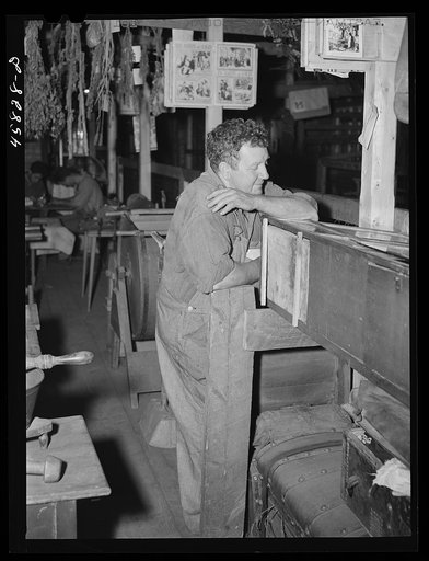 Untitled photo, possibly related to: Secretary of the fair pointing out exhibits to the visitors in the antique building at the World's Fair. Tunbridge, Vermont