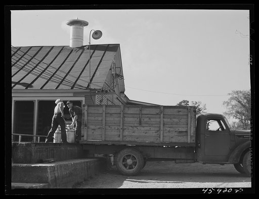 Untitled photo, possibly related to: Farmer unloading milk cans at the United Farmers' Co-op Creamery. East Berkshire, Vermont