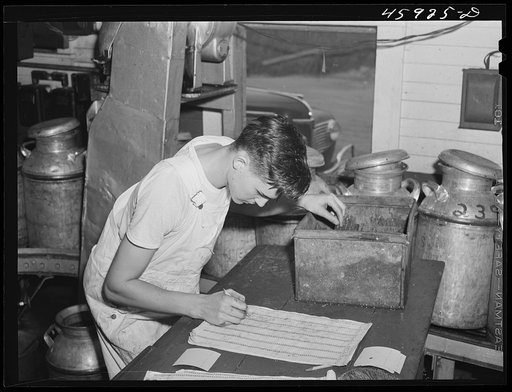 Recording the weight of milk at the United Farmers' Co-op Creamery in East Berkshire, Vermont