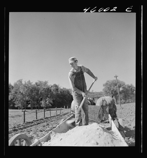 Untitled photo, possibly related to: Spreading lime in a field near Bakersfield, Vermont