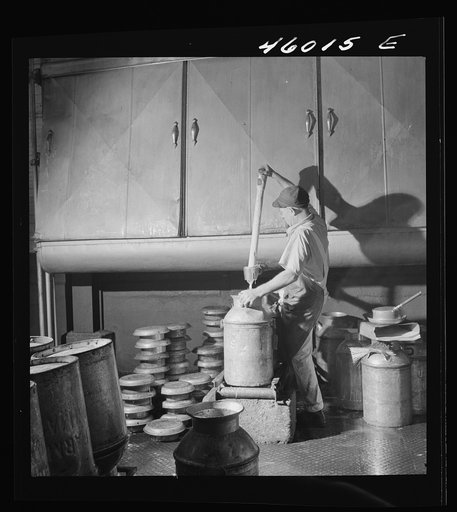 Filling milk cans with cream as it flows from the cooling unit, at the United Farmers' Cooperative Creamery, Sheldon Springs, Vermont