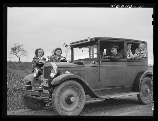 Children of Dan Sampson, who moved out of the Pine Camp expansion area in August, waiting in the family car for the school bus to take them to their new school near South Rutland, New York