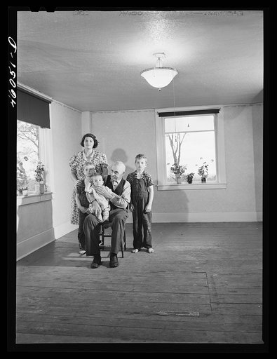 Mrs. Melvin Rivers, some of her children and her father-in-law in their new New York relocation corporation farm to which they have moved just recently, near Orwell, New York