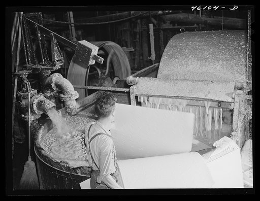 Putting paper pulp into vats which further churn the pulp at the Mississquoi Corporation paper mill in Seldon Springs, Vermont