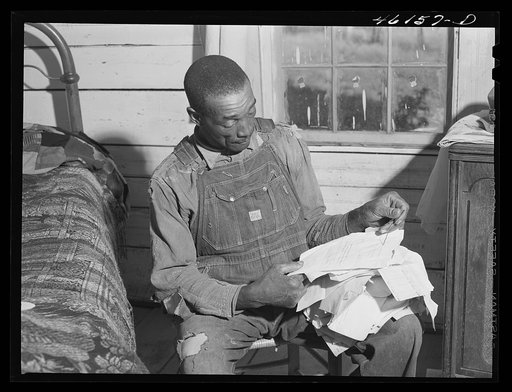 Untitled photo, possibly related to: Penfield, Greene County, Georgia (vicinity). Illiterate FSA (Farm Security Administration) client who keeps his government letters neatly strung on a wire