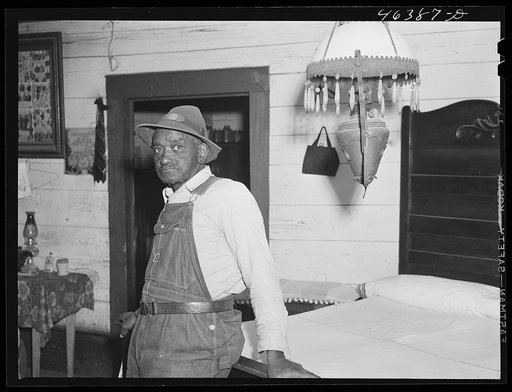 Untitled photo, possibly related to: George Ward and his wife and one of his five children with some of their canned goods. FSA (Farm Security Administration) clients in Meadow Crest, Greene County, Georgia