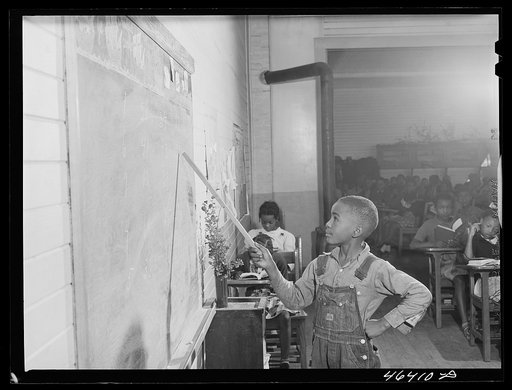 Untitled photo, possibly related to: Boyd Jones doing his arithmetic lesson at the blackboard in the Alexander Community School in Greene County, Georgia
