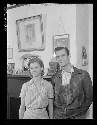 Two mill workers standing in living room with picture of F.D. Roosevelt on wall at left. Mr. and Mrs. Malcomb Mayfield, he is a young textile worker at the Mary Leila cotton mill in Greensboro, Greene County, Georgia