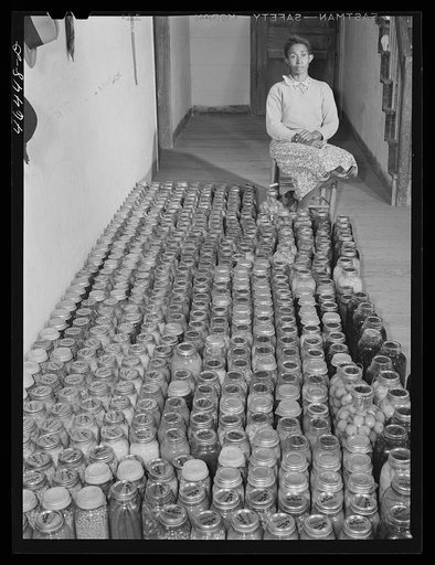Mrs. Edmond Reid], FSA (Farm Security Administration) client, with her canned goods. Oakland community, Greene County, Georgia