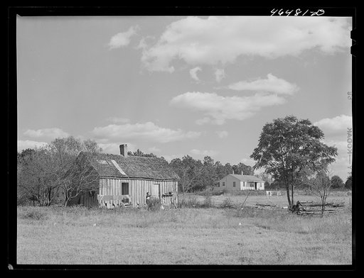 One of the new houses being built for FSA (Farm Security Administration) to replace some of the old, like the one at the left. Near Carey Station, Greene County, Georgia