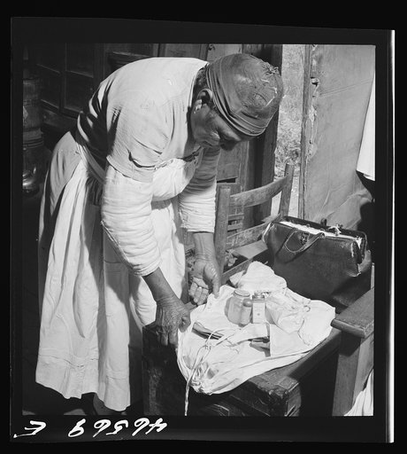 Midwife wrapping her kit to go on a call in Greene County, Georgia