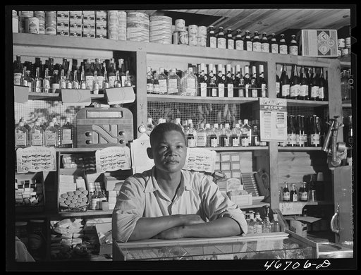 Untitled photo, possibly related to: Bayamon, Puerto Rico (vicinity). Proprietor of a small general store, which will soon be evacuated because it is in an area to be taken over by the Army