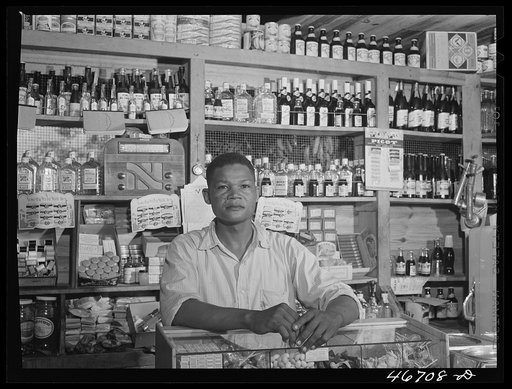 Bayamon, Puerto Rico (vicinity). Proprietor of a small general store, which will soon be evacuated because it is in an area to be taken over by the Army