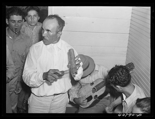 Corozal, Puerto Rico (vicinity). Ecequiel Irene, playing the "guiro" at the tenant purchase celebration at his house