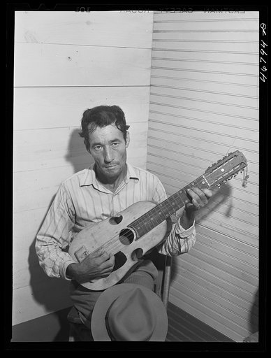Corozal, Puerto Rico (vicinity). Musician in the orchestra which furnished the music for dancing at the tenant purchase celebration. He is playing a "cuatro," a four-stringed guitar