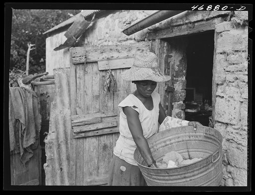 Saint Croix Island, Virgin Islands. Woman washing clothes in the slum village of Saint Johns