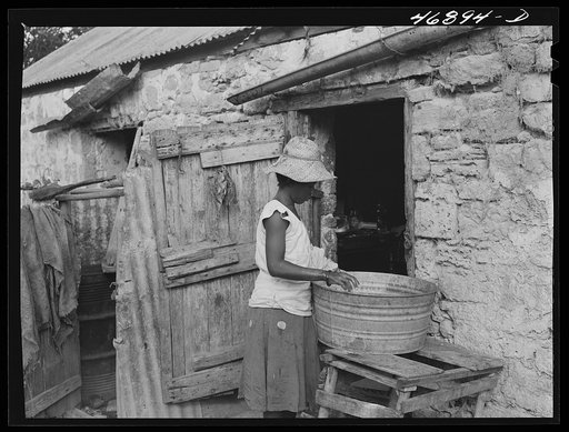 Untitled photo, possibly related to: Saint John, Saint Croix Island, Virgin Islands. Village house divided off into rooms, one for each family