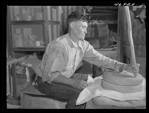 Frederiksted (vicinity), Saint Croix Island, Virgin Islands. Puerto Rican farmer grinding corn with stones he brought with him from Puerto Rico