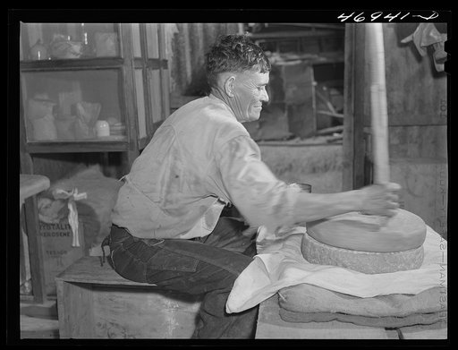 Untitled photo, possibly related to: Frederiksted (vicinity), Saint Croix Island, Virgin Islands. Puerto Rican farmer grinding corn with stones he brought with him from Puerto Rico
