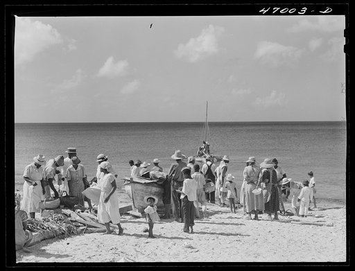 Untitled photo, possibly related to: Frederiksted, Saint Croix Island, Virgin Islands. Housewives at the seashore waiting for the fishing boats to come in