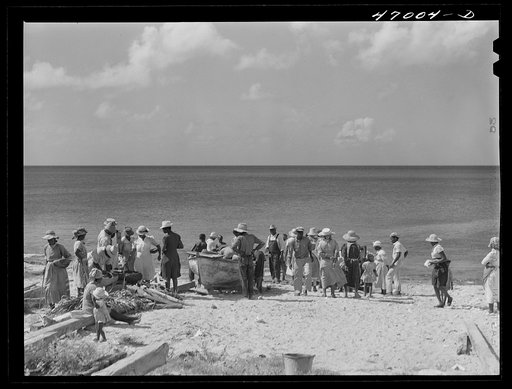 Frederiksted, Saint Croix Island, Virgin Islands. Housewives at the seashore waiting for the fishing boats to come in