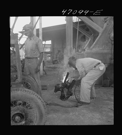Untitled photo, possibly related to: Saint Croix Island, Virgin Islands. Reconditioning machinery in the Bethlehem sugar mill