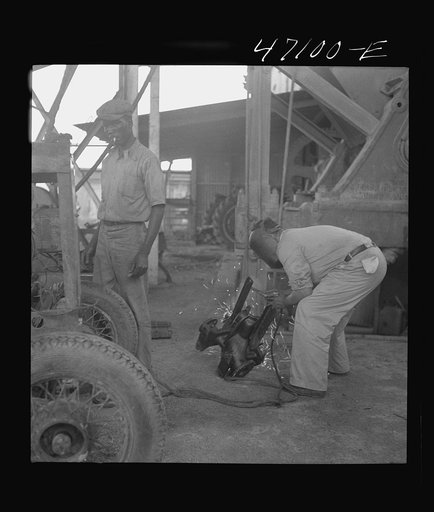 Untitled photo, possibly related to: Saint Croix Island, Virgin Islands. Reconditioning machinery in the Bethlehem sugar mill