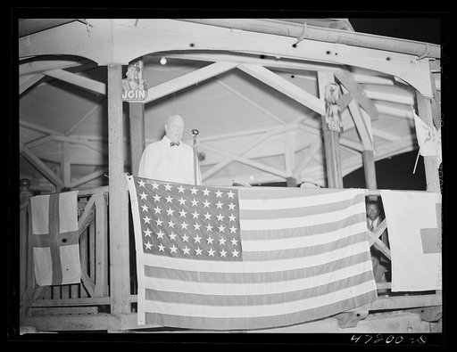 Untitled photo, possibly related to: Charlotte Amalie, Saint Thomas Island, Virgin Islands. Secretary to Governor, Robert Morse Lovett, addressing the audience at the Red Cross meeting held in the square