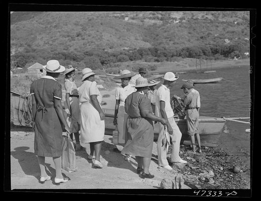 French village, a small settlement on Saint Thomas Island, Virgin Islands. Women come down to the French village, a small settlement, to buy fish from the incoming boats