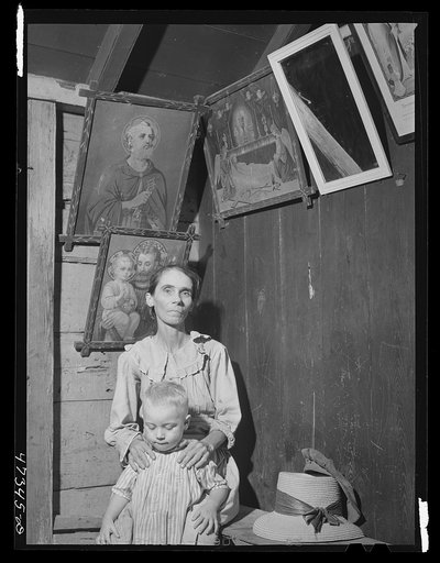 French village, a small settlement on Saint Thomas Island, Virgin Islands. French woman and one of her children in her home in the French village, a small settlement