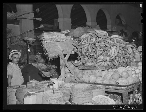 Rio Piedras, Puerto Rico. Bananas, coconuts, rice, beans and other produce for sale at the produce market