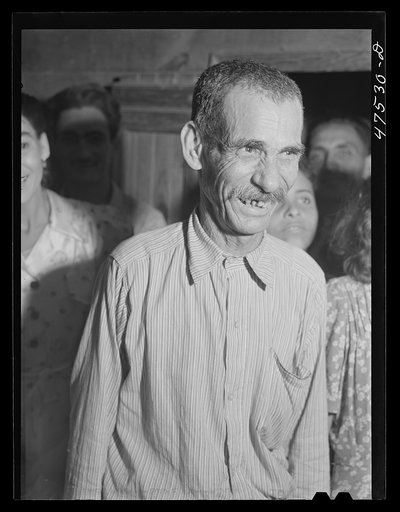 Guanica, Puerto Rico (vicinity). Tenant farmer at a Three Kings' eve party which is an annual event at his home in the sugar country