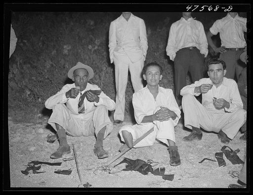 Untitled photo, possibly related to: Guanica, Puerto Rico (vicinity). Eating "pastellas" at a Three Kings' eve party at the home of a farm laborer