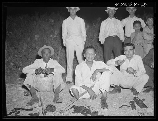 Guanica, Puerto Rico (vicinity). Eating "pastellas" at a Three Kings' eve party at the home of a farm laborer