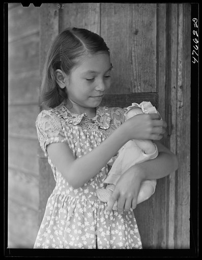 Untitled photo, possibly related to: Guanica, Puerto Rico (vicinity). One of the children of a tenant farmer and her Three Kings' day present